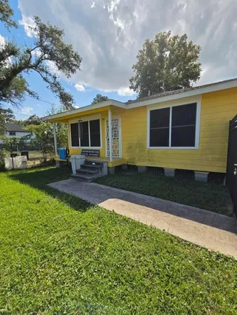 a front view of house with yard and outdoor seating