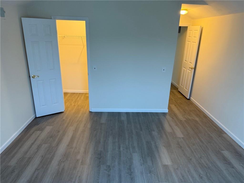 7 Georgetown Lane Brooklyn, NY 11234 - Photo 18 of 32 a view of an empty room with wooden floor and a window