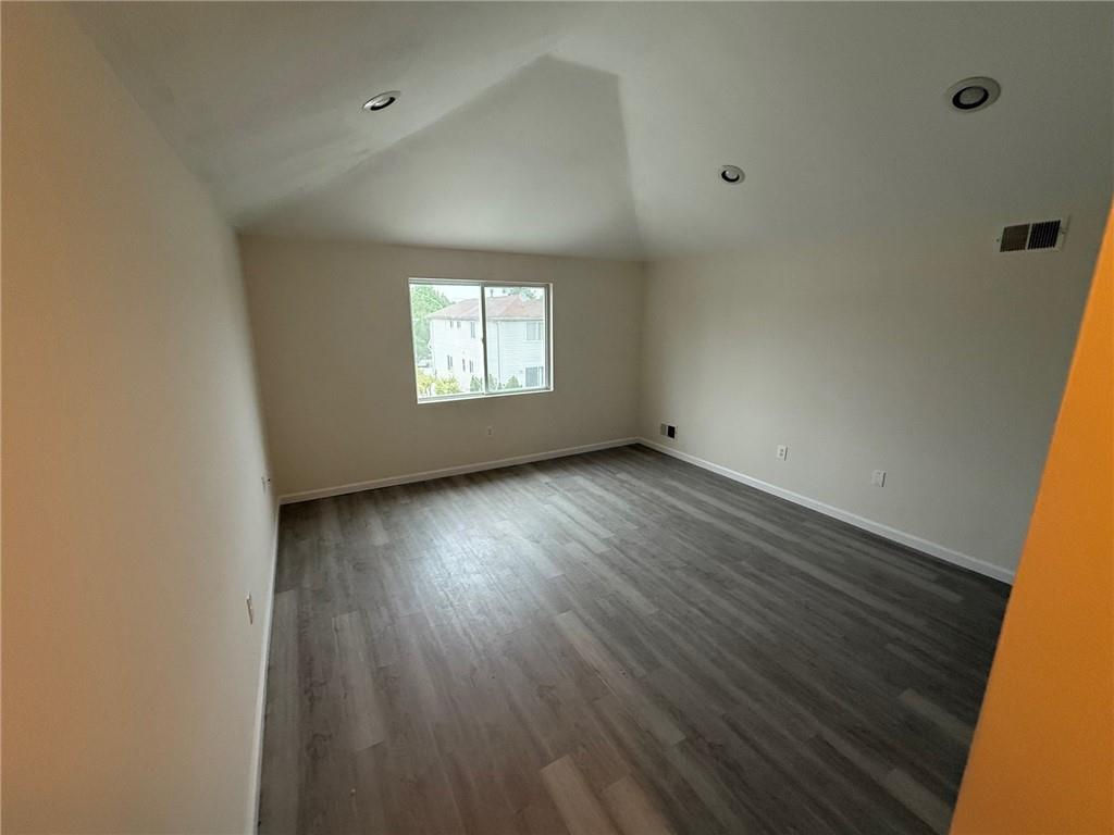 7 Georgetown Lane Brooklyn, NY 11234 - Photo 19 of 32 an empty room with wooden floor and windows