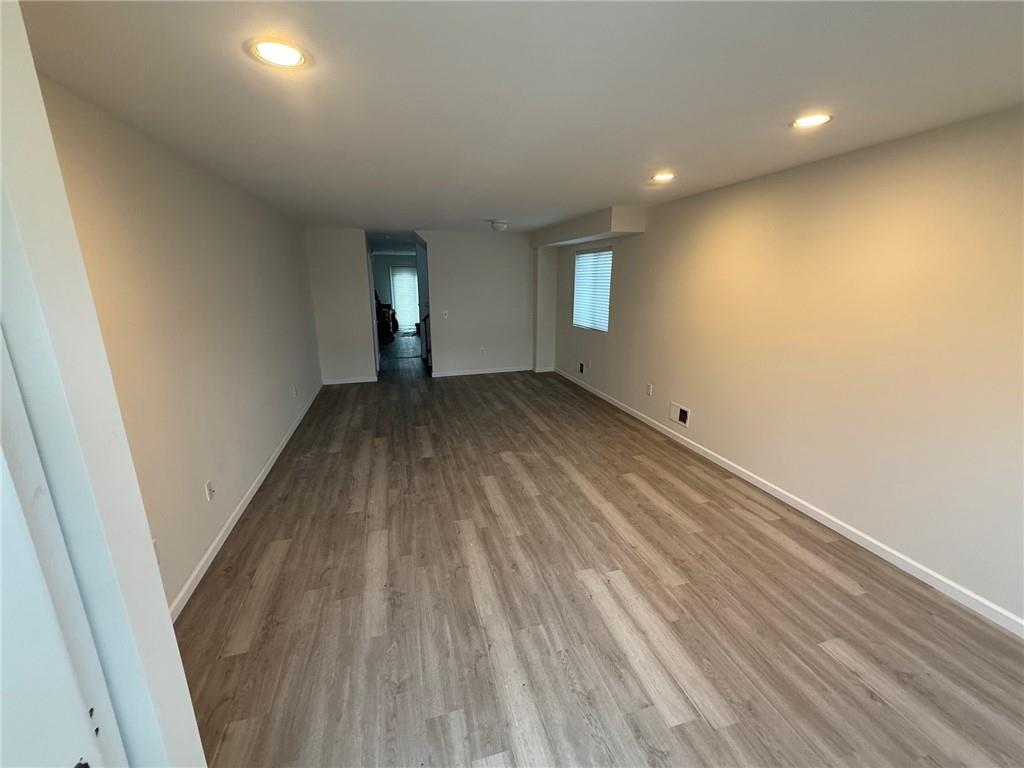 7 Georgetown Lane Brooklyn, NY 11234 - Photo 2 of 32 an empty room with wooden floor and windows