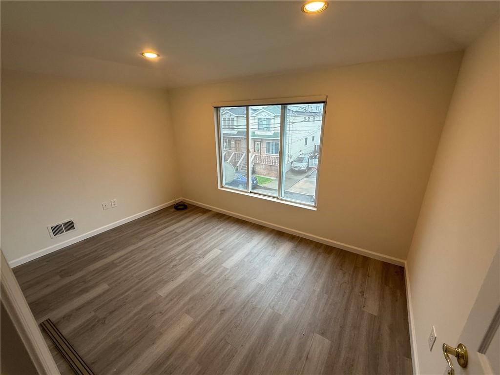 7 Georgetown Lane Brooklyn, NY 11234 - Photo 21 of 32 an empty room with wooden floor and windows