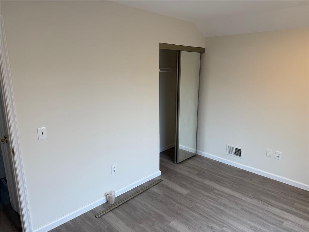7 Georgetown Lane Brooklyn, NY 11234 - Photo 22 of 32 an empty room with wooden floor and closet