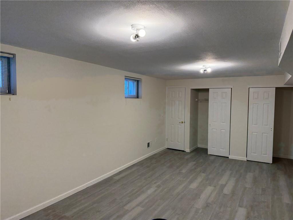 7 Georgetown Lane Brooklyn, NY 11234 - Photo 26 of 32 an empty room with wooden floor and windows