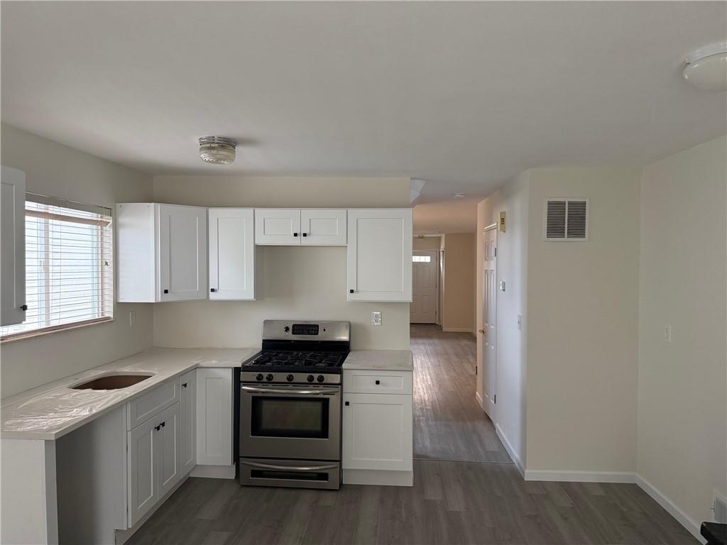 7 Georgetown Lane Brooklyn, NY 11234 - Photo 7 of 32 a kitchen with stainless steel appliances a stove and a refrigerator