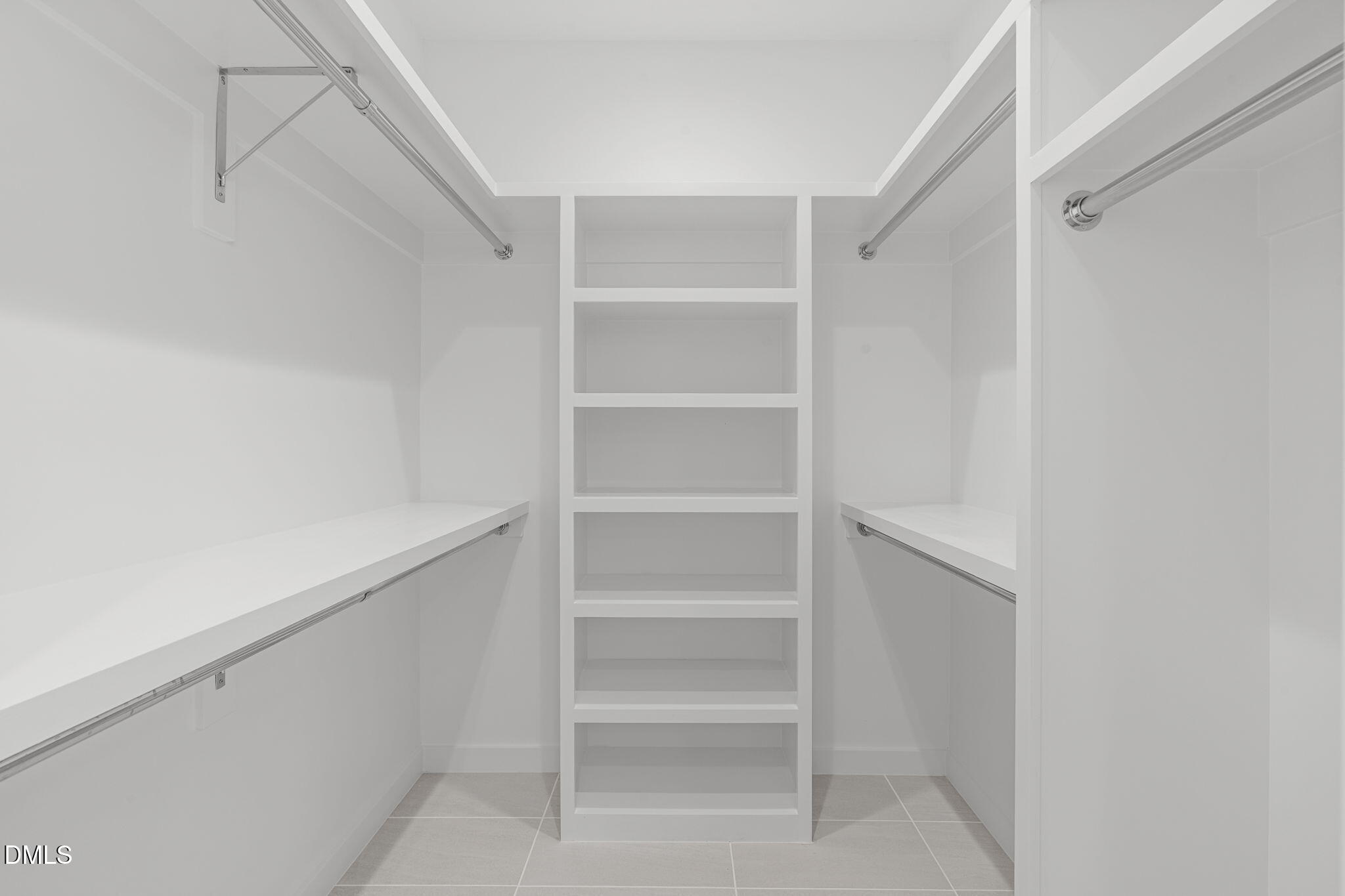 501 South Bloodworth Street, Unit 105 Raleigh, NC 27601 - Photo 28 of 59 a view of walk in closet with empty racks