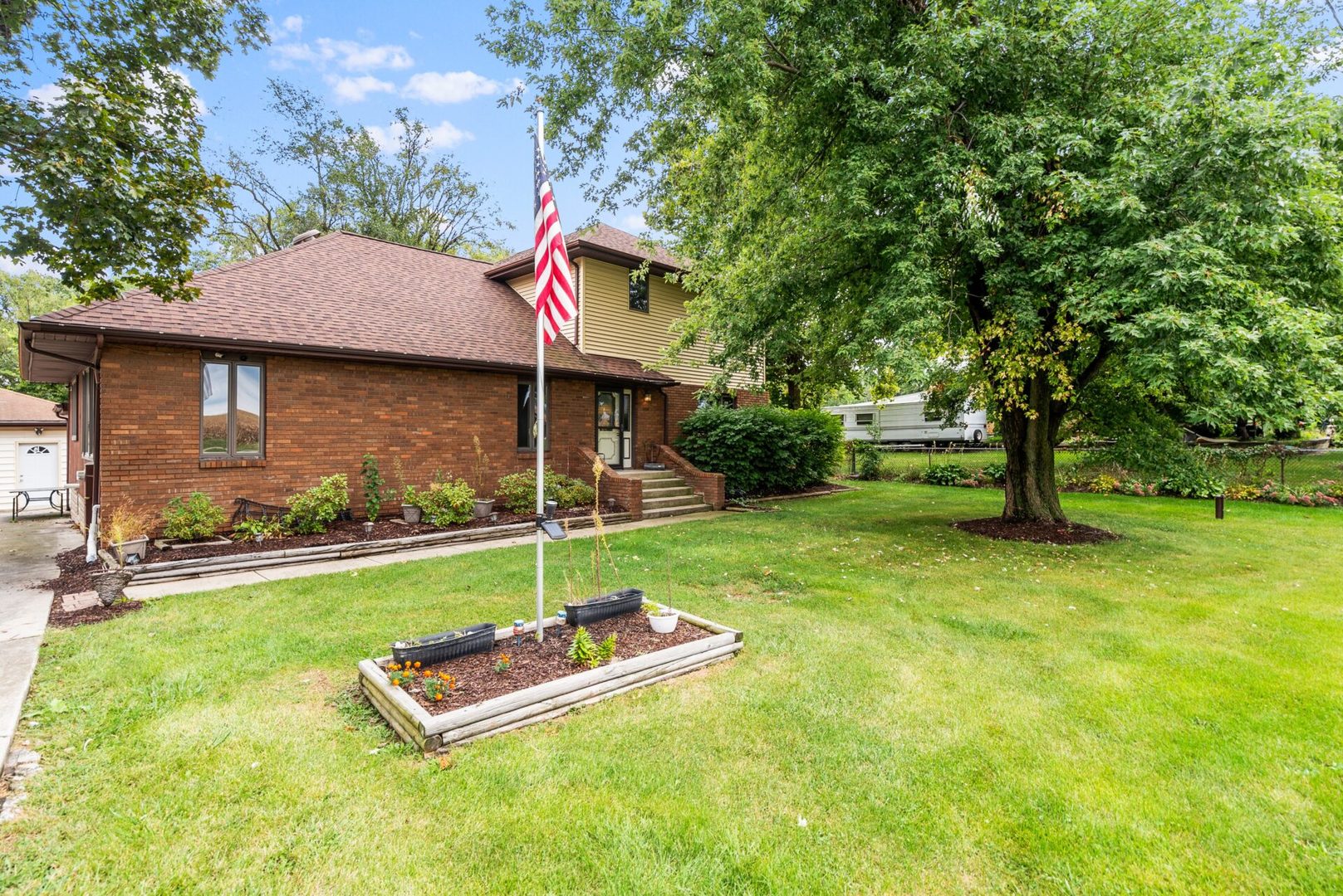 25123 South Chicago Road Elwood, IL 60421 - Photo 2 of 42 a front view of a house with a yard table and chairs