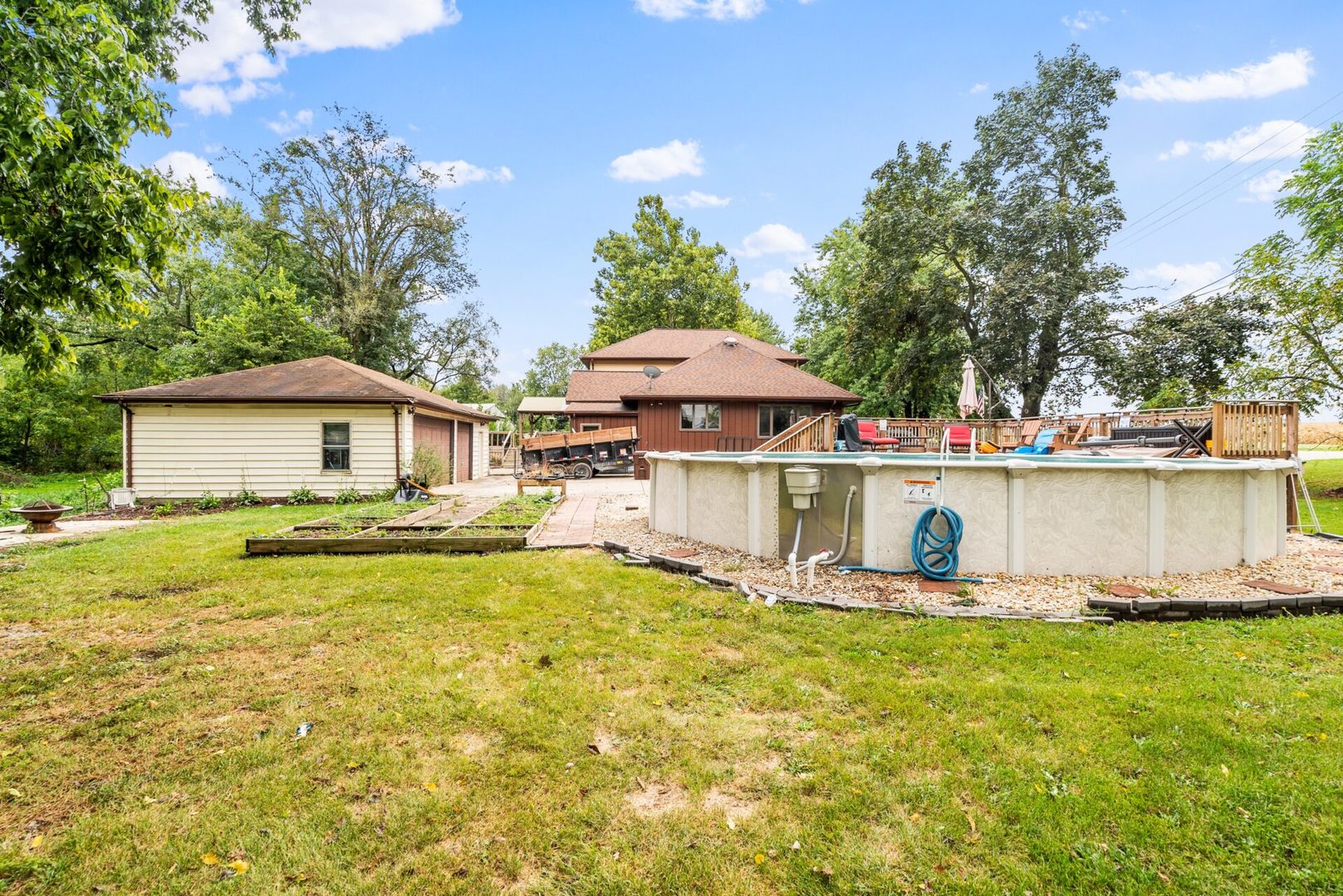 25123 South Chicago Road Elwood, IL 60421 - Photo 30 of 42 a view of a house with pool and chairs under an umbrella