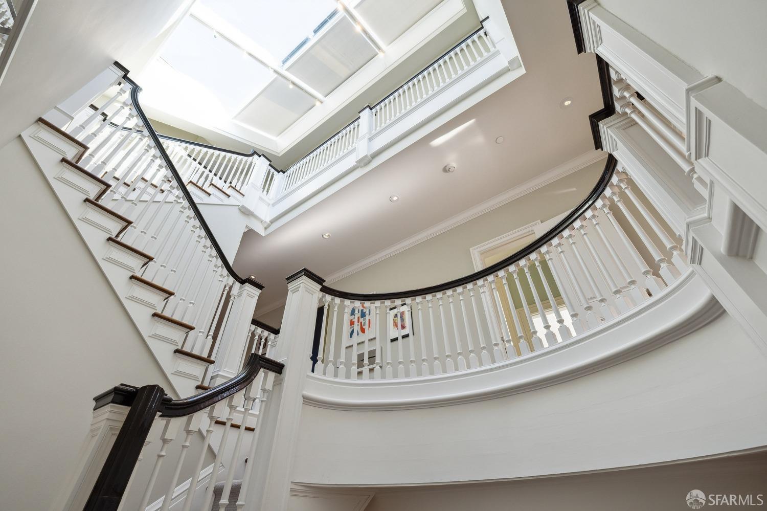 2480 Broadway San Francisco, CA 94115 - Photo 21 of 70 a view of staircase with white walls and a chandelier