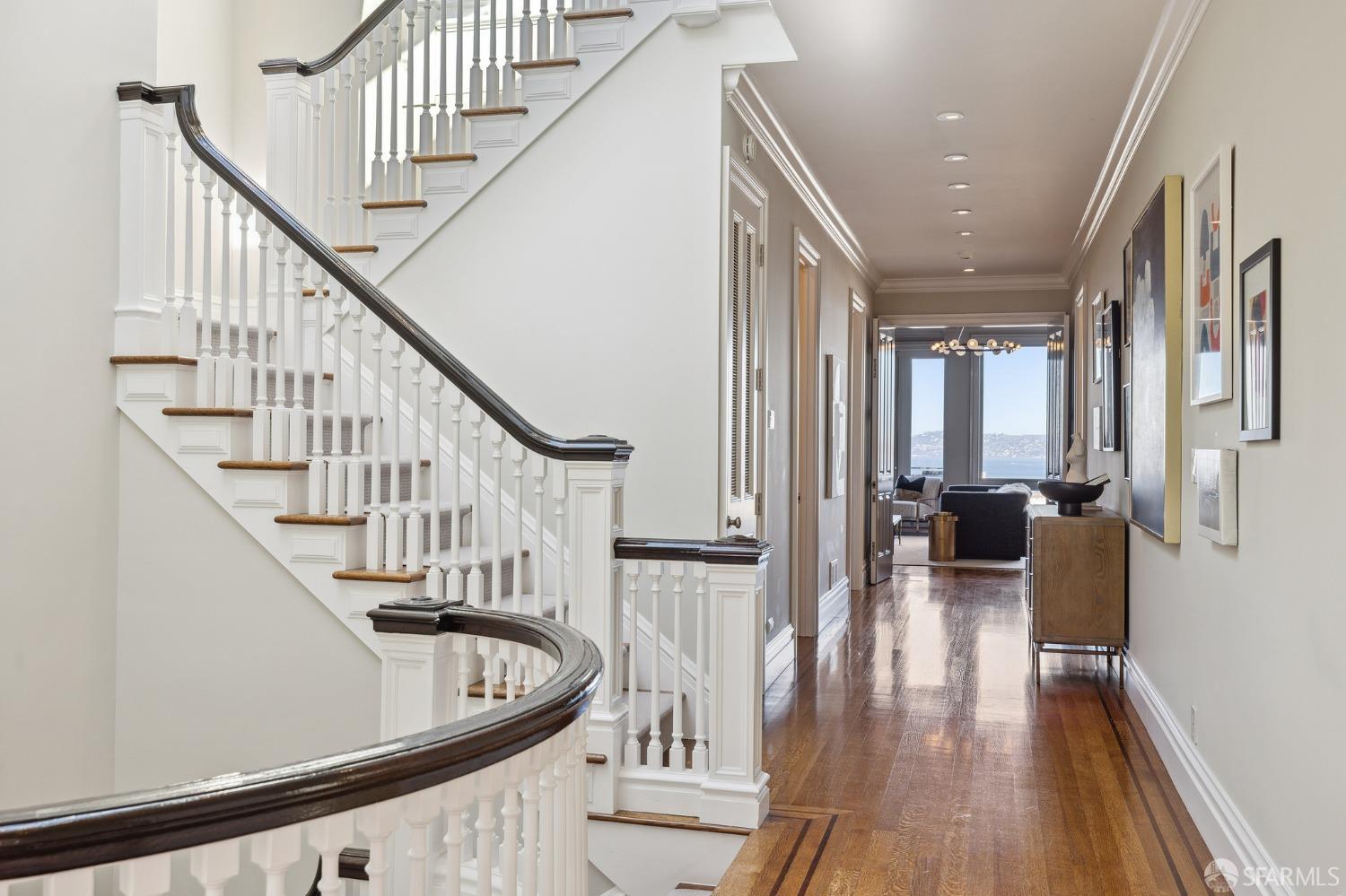 2480 Broadway San Francisco, CA 94115 - Photo 22 of 70 a view of staircase with lots of frames on wall and wooden floor