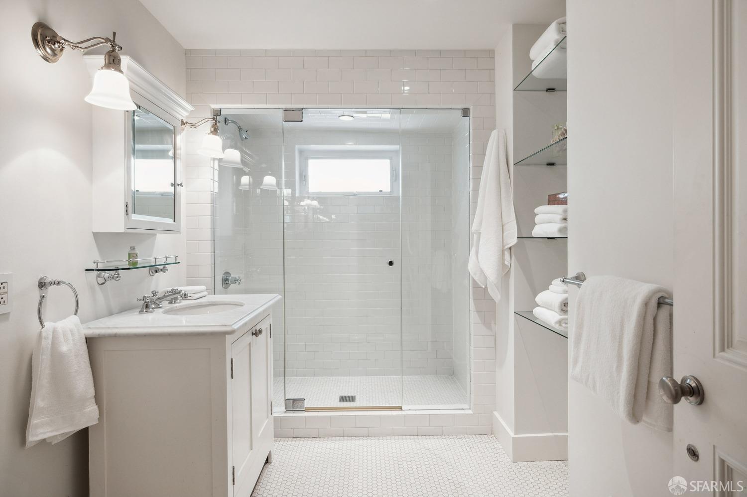 2480 Broadway San Francisco, CA 94115 - Photo 50 of 70 a bathroom with a shower a mirror and a sink