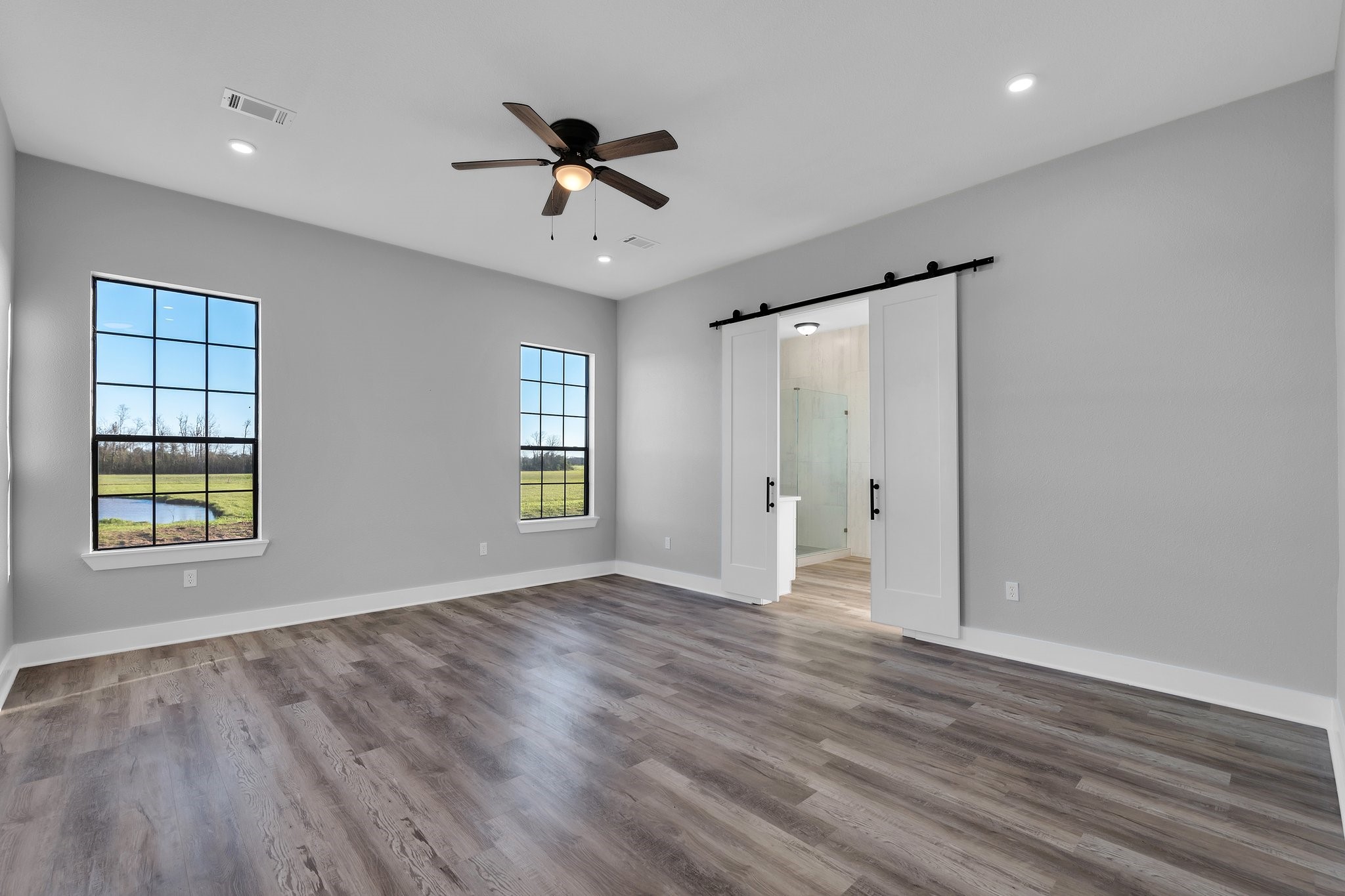 519 Chuckwagon Trail Angleton, TX 77515 - Photo 15 of 34 a view of an empty room with a window and wooden floor