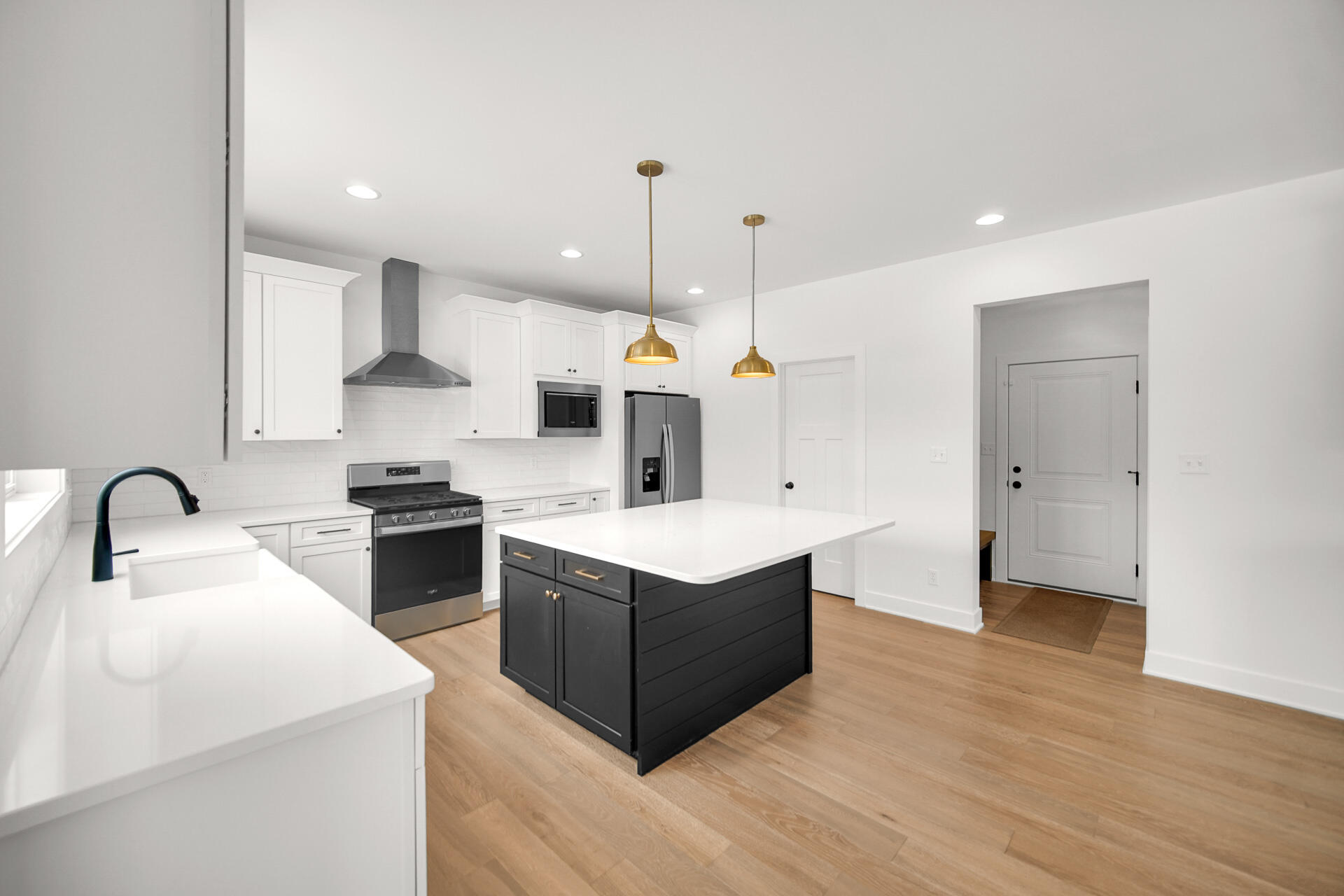 1079 Kleven Lane Crown Point, IN 46307 - Photo 12 of 37 a kitchen with a stove a sink a kitchen island with wooden cabinets and floor