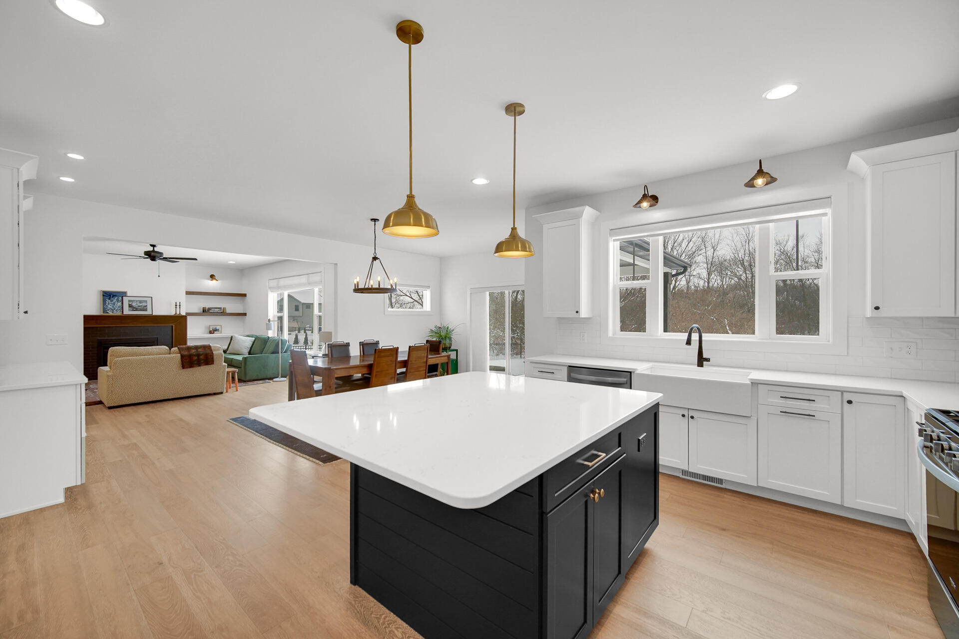1079 Kleven Lane Crown Point, IN 46307 - Photo 15 of 37 a large kitchen with kitchen island a stove a sink a center island and a wooden floor