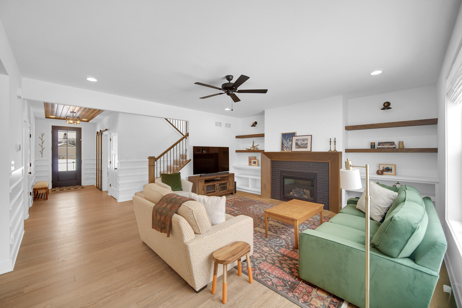 1079 Kleven Lane Crown Point, IN 46307 - Photo 30 of 37 a living room with furniture a ceiling fan and a flat screen tv