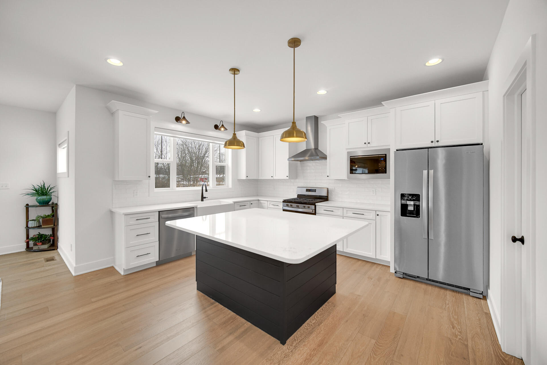 1079 Kleven Lane Crown Point, IN 46307 - Photo 10 of 37 a kitchen with white cabinets and stainless steel appliances