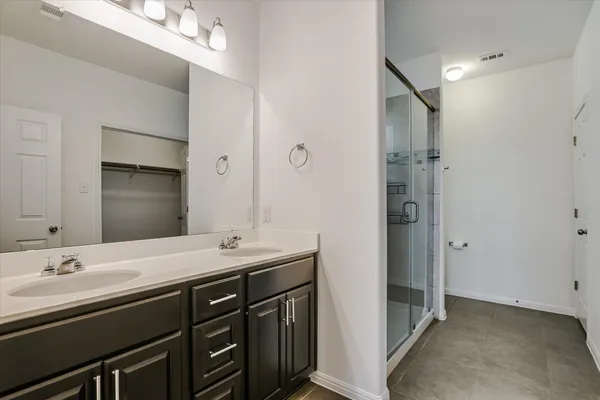 a bathroom with a double vanity sink and mirror