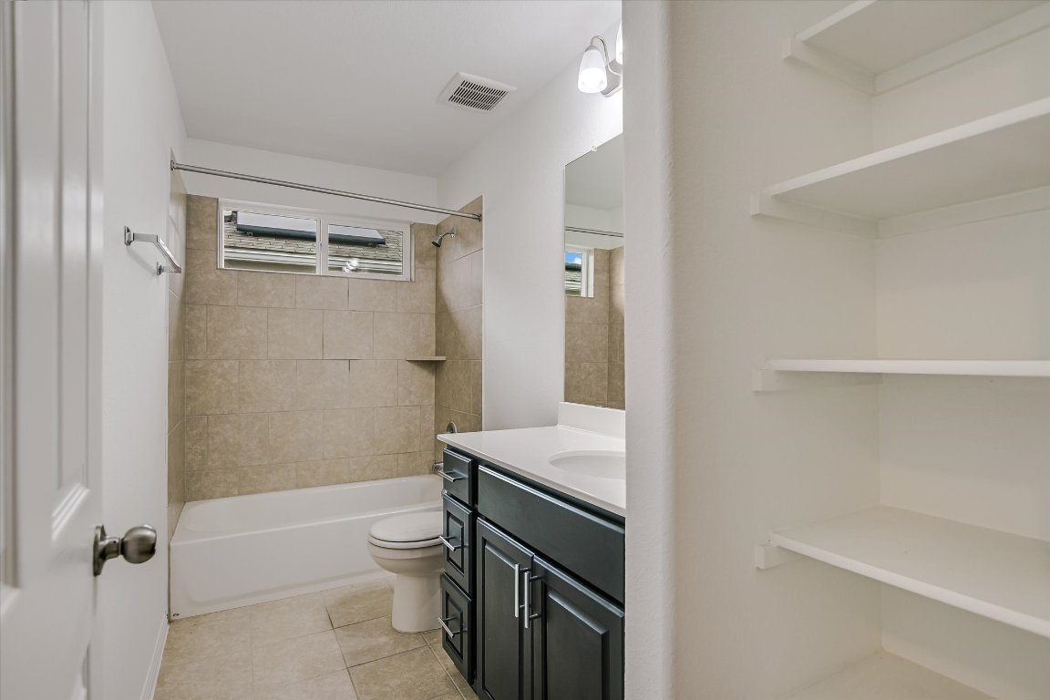 12814 Meachum Lane Manor, TX 78653 - Photo 15 of 20 a bathroom with a granite countertop sink toilet and shower