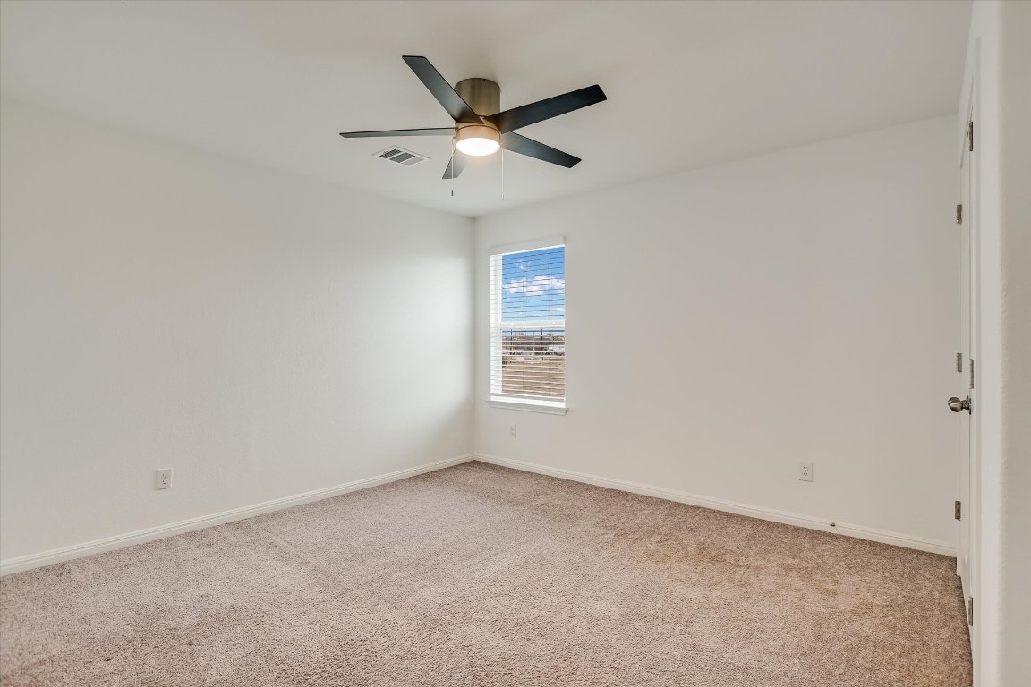 12814 Meachum Lane Manor, TX 78653 - Photo 17 of 20 an empty room with ceiling fan and window