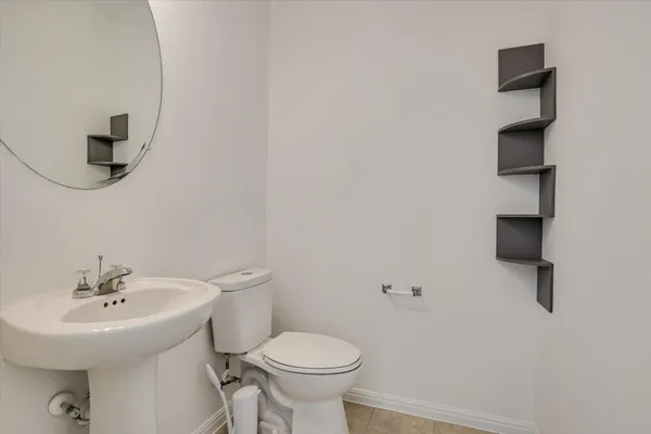 a bathroom with a sink toilet and a mirror