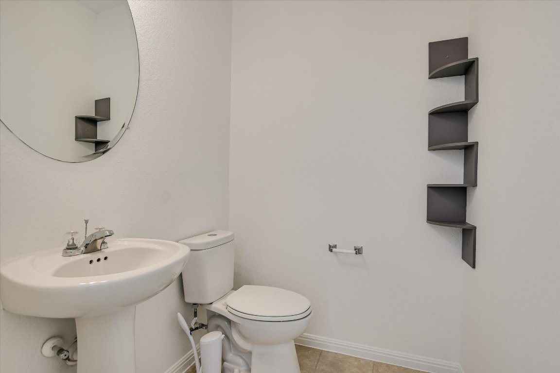 12814 Meachum Lane Manor, TX 78653 - Photo 9 of 20 a bathroom with a sink toilet and a mirror