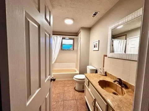 a bathroom with a sink a toilet and shower curtain
