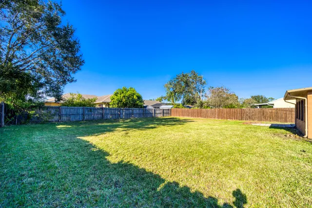 a view of a swimming pool with an outdoor seating and a yard