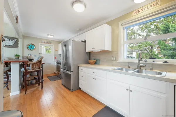 a kitchen with a sink window and cabinets