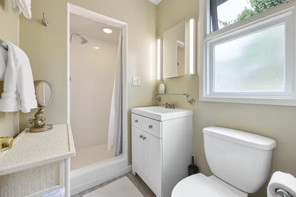 a bathroom with a toilet sink and mirror