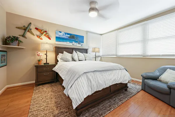 a bedroom with a bed couch and a window