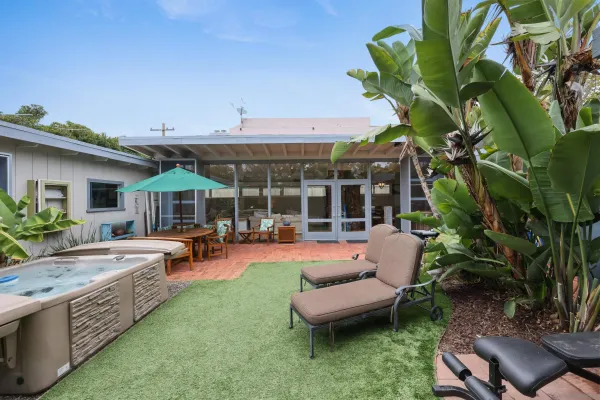 a backyard of a house with yard table and chairs