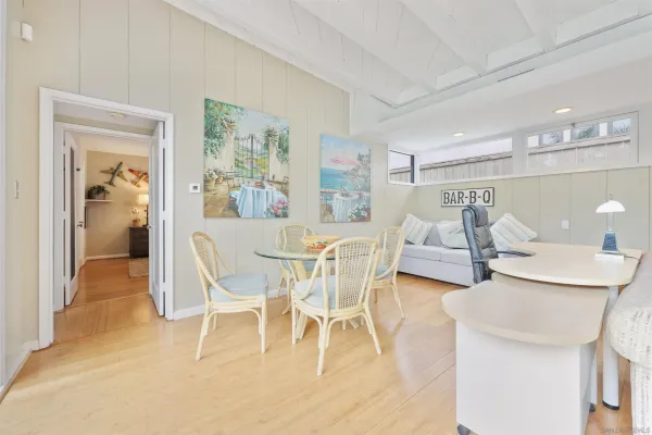 a dining room with furniture and wooden floor