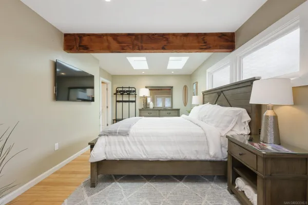 a bedroom with a bed and a flat screen tv