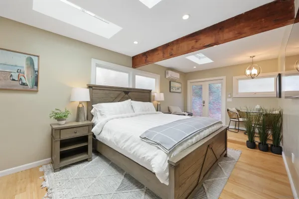 a spacious bedroom with a bed and a chandelier