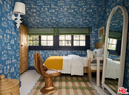 a bed sitting in a bedroom next to a couch