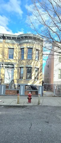 a front view of a residential apartment building with a yard