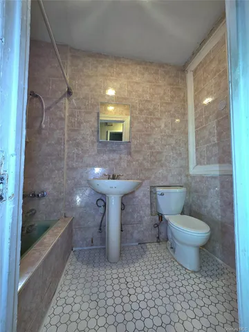 a view of kitchen with stainless steel appliances granite countertop a refrigerator and a stove top oven