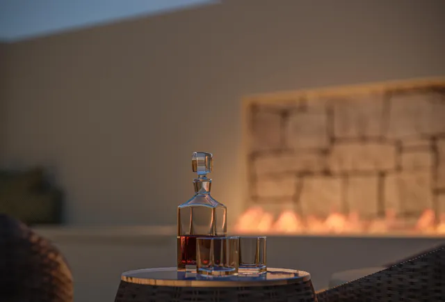 a view of a livingroom with furniture and a work table in a room