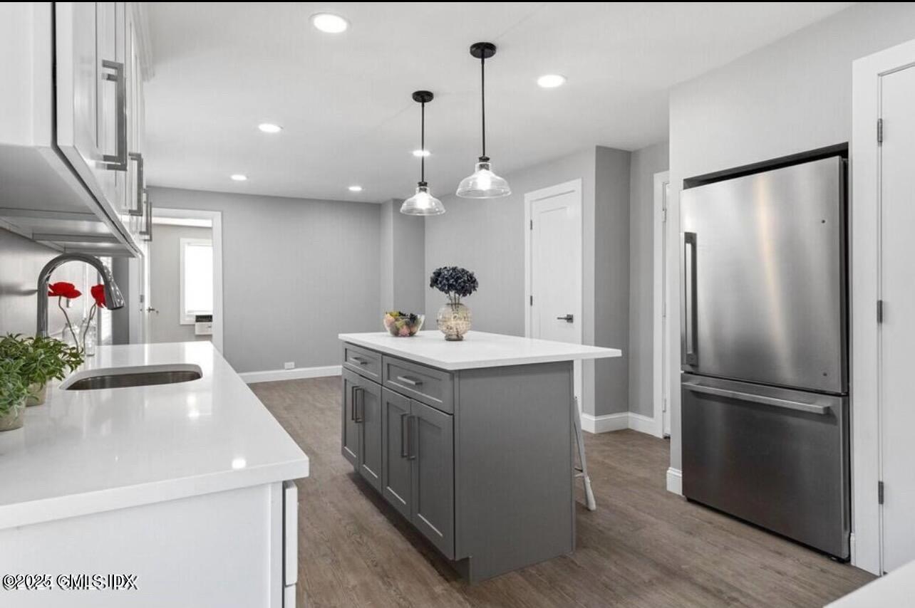 a kitchen with a sink stainless steel appliances and ceiling fan