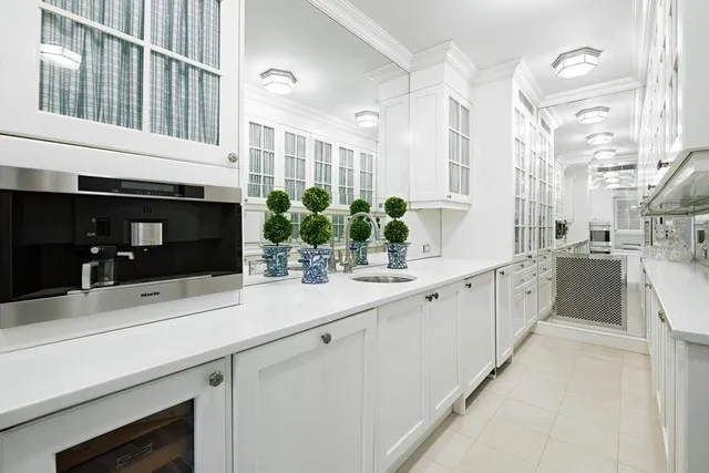 a kitchen with stainless steel appliances a stove a sink and a refrigerator