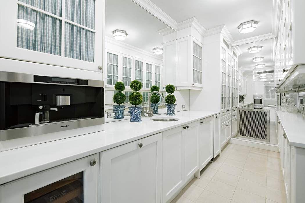 4 East 72nd Street, Unit 3/4B Manhattan, NY 10021 - Photo 7 of 15 a kitchen with stainless steel appliances a sink and a counter top space