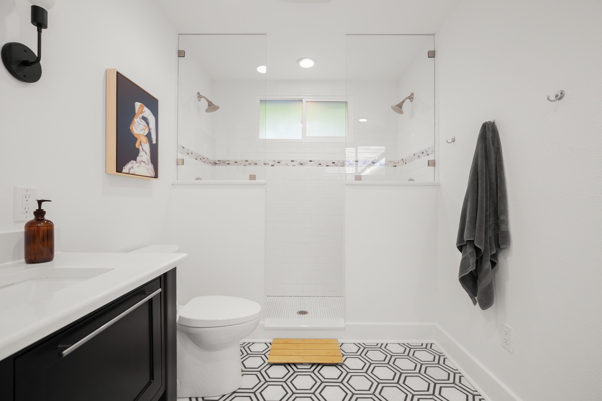 2010 Alegria Road Austin, TX 78757 - Photo 17 of 35 Hexagonal tile flooring complements a walk-in shower with clear glass enclosure