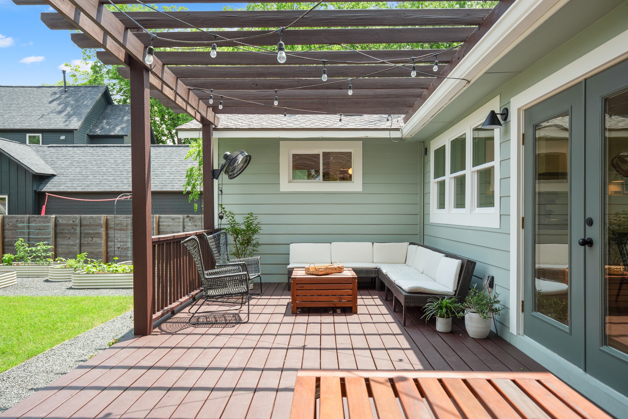 2010 Alegria Road Austin, TX 78757 - Photo 28 of 35 Spacious outdoor deck with a pergola, string lighting, and direct access to the interior via glass-paneled double doors