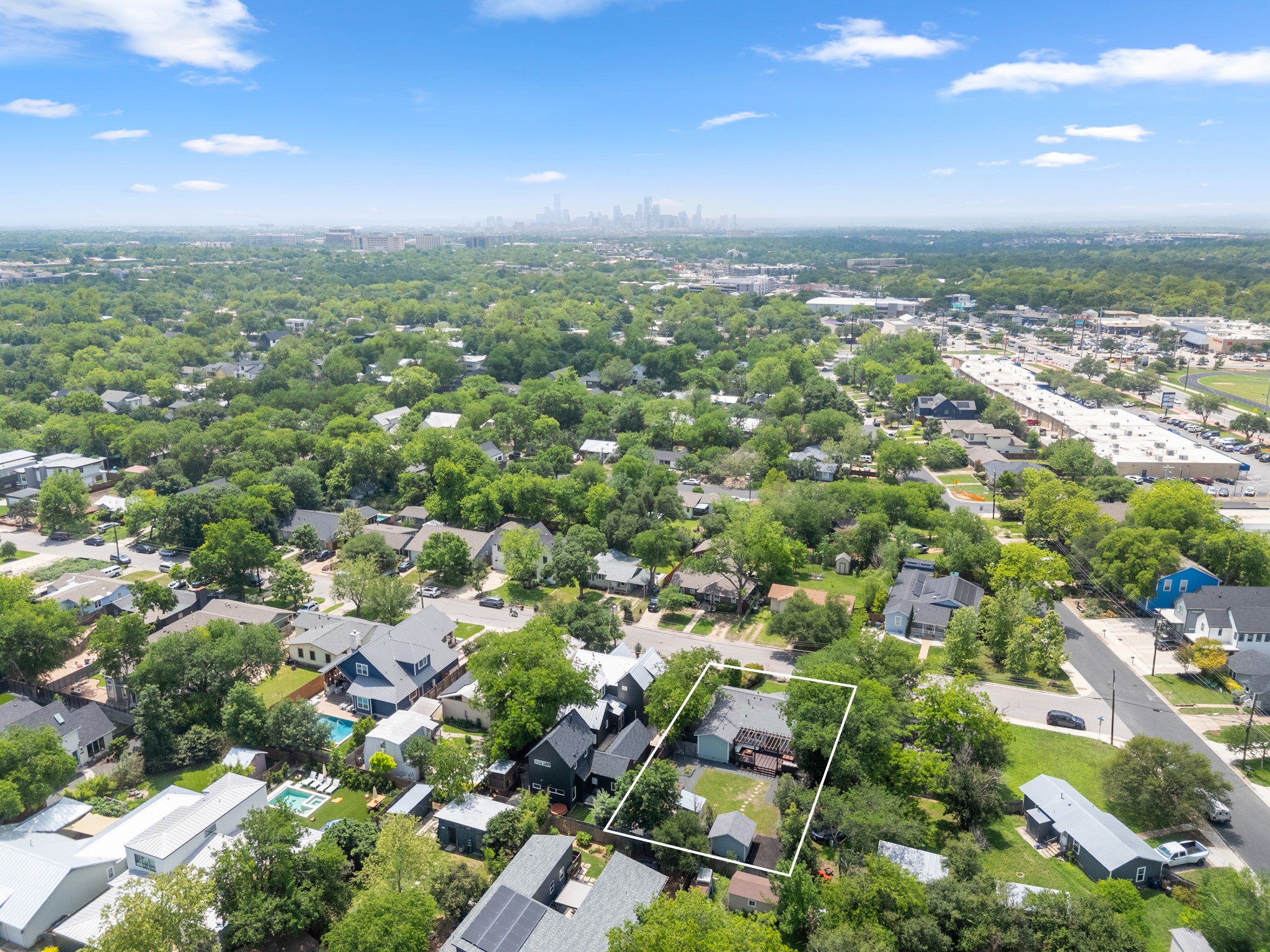 2010 Alegria Road Austin, TX 78757 - Photo 35 of 35 Aerial perspective showcasing a residential property with a multi-level deck, expansive backyard space, and surrounding mature trees