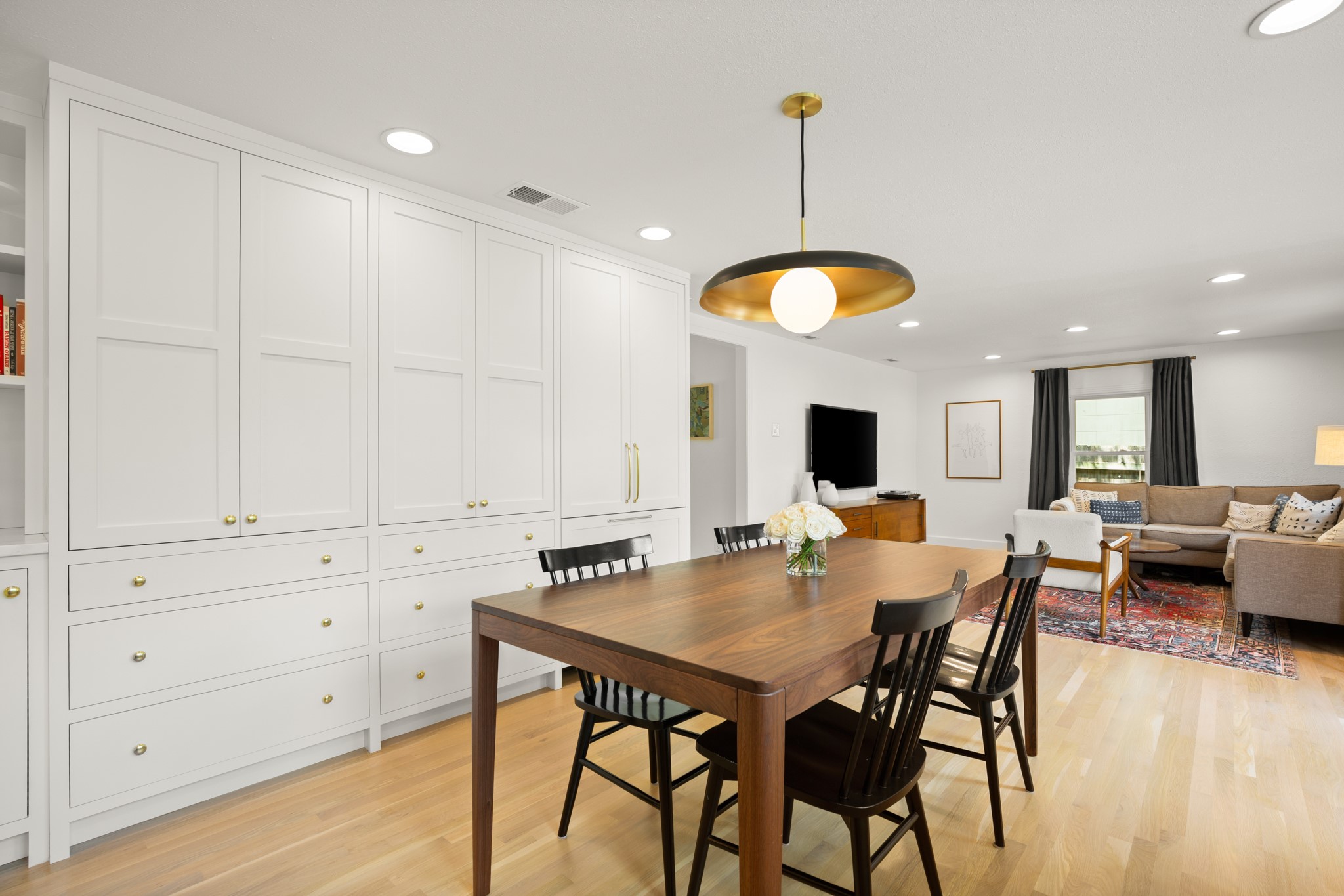 2010 Alegria Road Austin, TX 78757 - Photo 10 of 35 Expansive white built-in cabinetry and refrigerator with brass hardware and integrated shelving