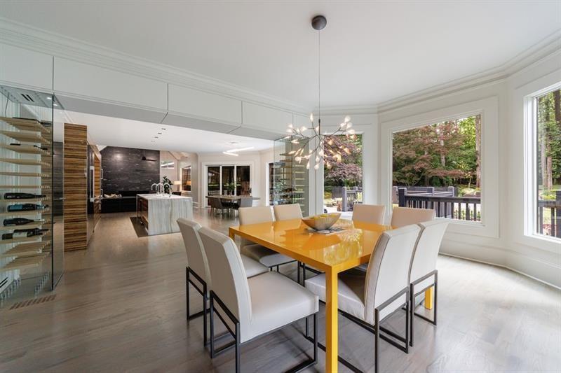 3117 West Roxboro Road Northeast Atlanta, GA 30324 - Photo 12 of 78 a dining room with furniture a chandelier and wooden floor