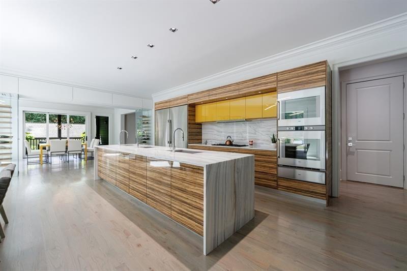 3117 West Roxboro Road Northeast Atlanta, GA 30324 - Photo 20 of 78 a view of kitchen with kitchen island wooden floor center island and stainless steel appliances