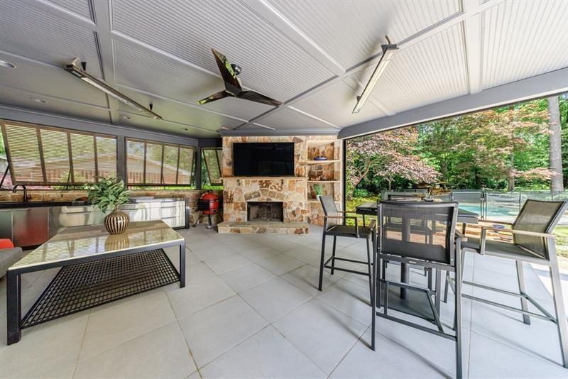 3117 West Roxboro Road Northeast Atlanta, GA 30324 - Photo 30 of 78 a living room with furniture a fireplace and a table