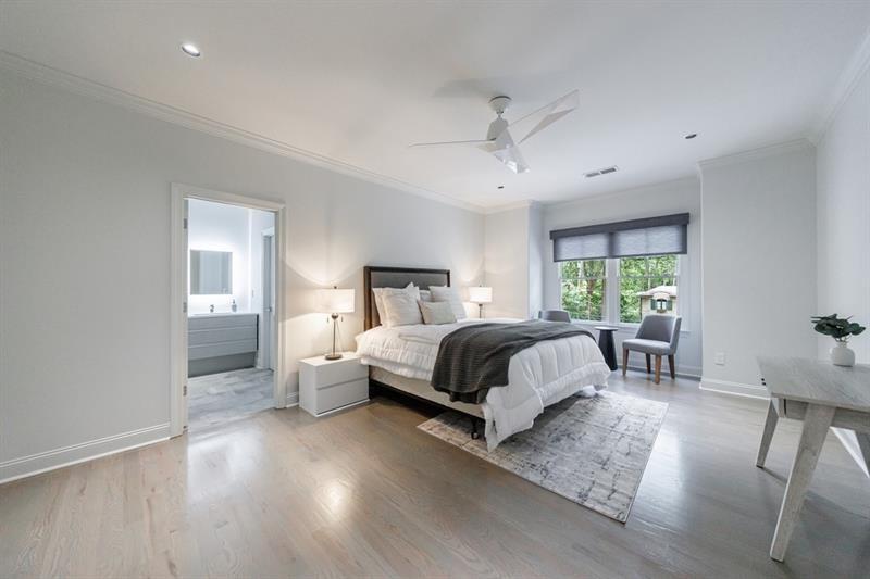 3117 West Roxboro Road Northeast Atlanta, GA 30324 - Photo 46 of 78 a bedroom with a large bed and a chandelier