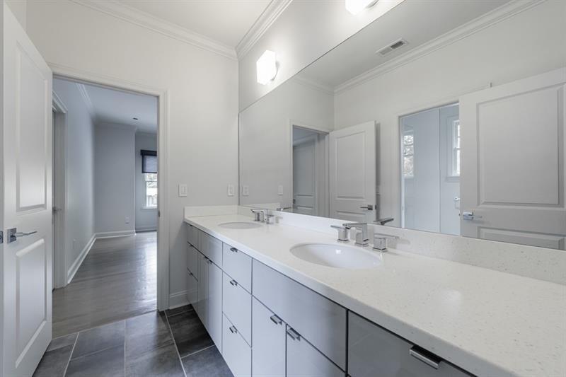 3117 West Roxboro Road Northeast Atlanta, GA 30324 - Photo 49 of 78 a bathroom with double vanity sinks and a mirror