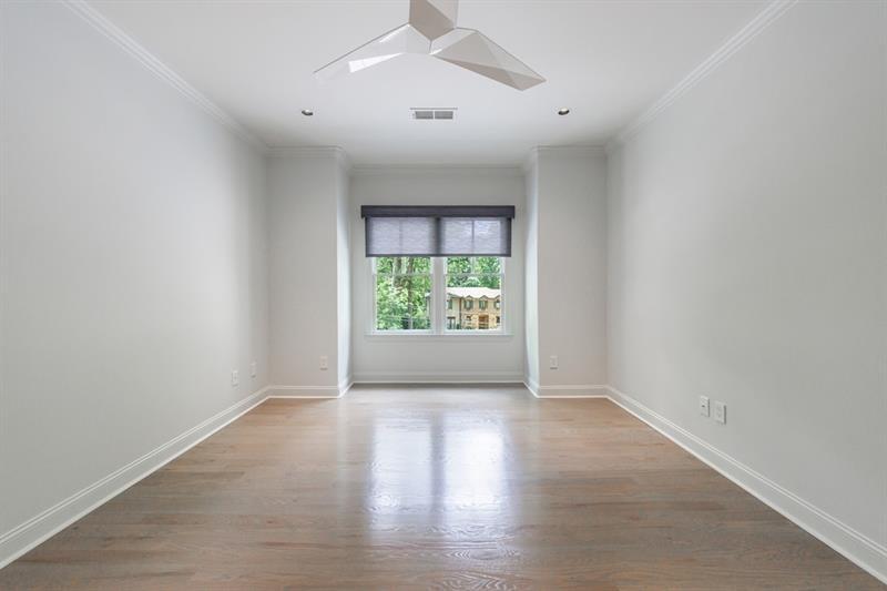 3117 West Roxboro Road Northeast Atlanta, GA 30324 - Photo 50 of 78 an empty room with wooden floor and windows